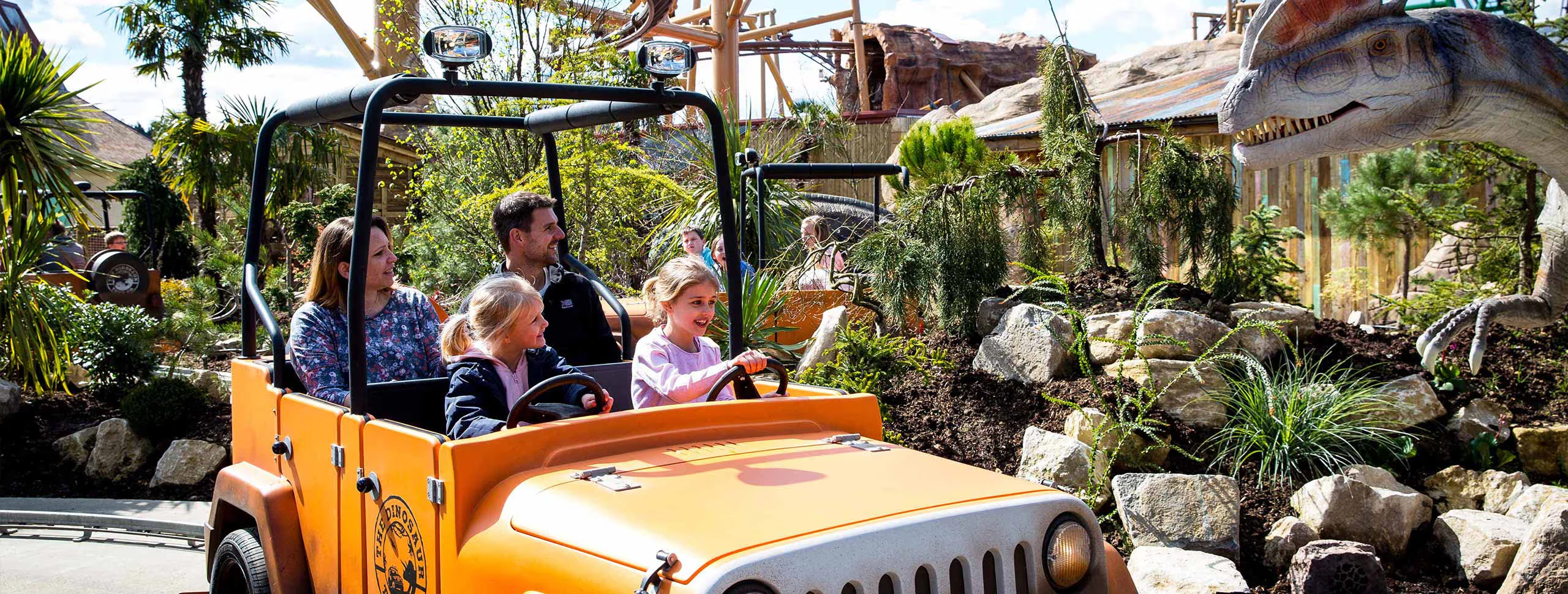 Family enjoying a dinosaur ride at Paultons Park