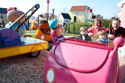 Family enjoying a Peppa Pig World ride during a November break